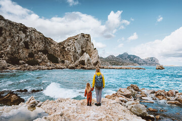 Mother and child traveling in Greece walking on the beach Rhodes island outdoor family lifestyle...