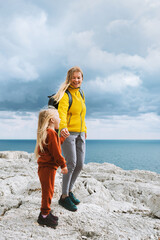 Mother and daughter child hiking together family traveling in Greece, mom and kid on active...