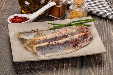 Salted marinated herring fillet with spices