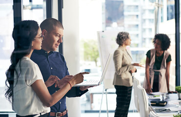 Laptop, talking and teamwork with business people in office for meeting or planning together....