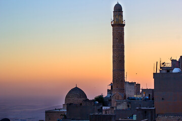 MARDIN TURKEY Majestic Mosque Minaret at Sunrise over a Cityscape. A stunning vista of a mosque's...