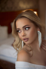 Portrait of a beautiful bridesmaid sitting in a hotel on her wedding morning