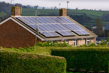 Solar panels on the roof of a house in Crediton in spring, Devon, England, Europe.