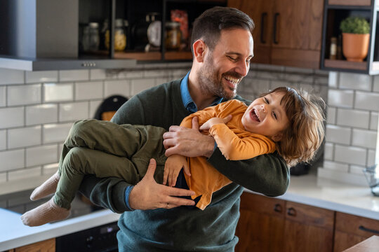 Portrait of father and son having fun at home, family life, parenting, love and bonding concepts