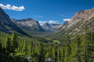Fototapeta premium Celebrate National Park Week with breathtaking mountain vistas that highlight dramatic peaks, clear skies, and vast valleys bathed in golden sunlight