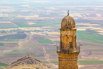 Mardin Ancient minaret overlooking a fertile valley. A high-angle, full shot of a historic minaret,...