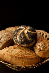 Freshly baked bun with poppy seeds. Assorted fresh pastries. Bread in a basket
