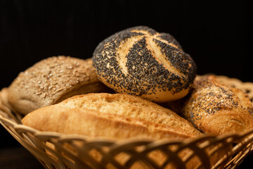 Freshly baked bun with poppy seeds. Assorted fresh pastries. Bread in a basket