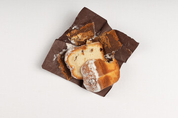 A sliced portion of sweet bread with raisins, resting on a brown parchment paper.