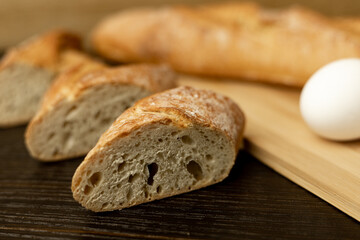 Flour, egg, rolling pin close-up.Bread in clay plate.The process of making bread