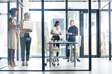 Fototapeta premium Boardroom, glass office and meeting with business people at work together for discussion or planning. Collaboration, project management or workshop with man and woman employee group in conversation