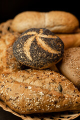 Freshly baked bun with poppy seeds. Assorted fresh pastries. Bread in a basket