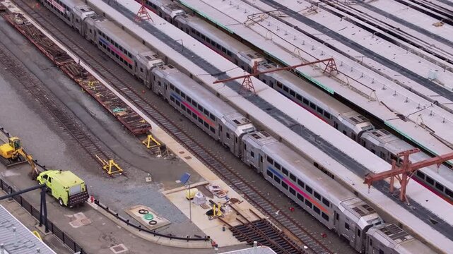Train yard revealing infrastructure network with parked locomotives standing side by side, capturing urban transportation landscape of a metropolitan area