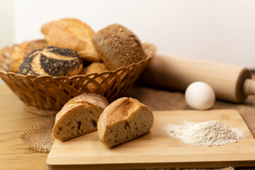 Sliced bread on the table, flour, egg. Homemade pastries. Freshly baked buns