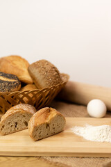 Sliced bread on the table, flour, egg. Homemade pastries. Freshly baked buns