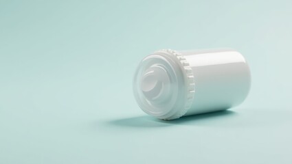 Mounjaro For Weight Loss. White plastic medicine bottle with child-resistant cap lying on light blue surface, ideal for pharmaceutical packaging, healthcare, medical, and wellness promotions, clean m