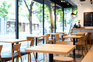Fototapeta premium modern cafe interior with wooden tables and chairs, large windows, and bright atmosphere. space is inviting and perfect for relaxation or work
