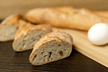 Slices of sliced bread on the table.Flour, egg, bread close-up.Homewort pastries