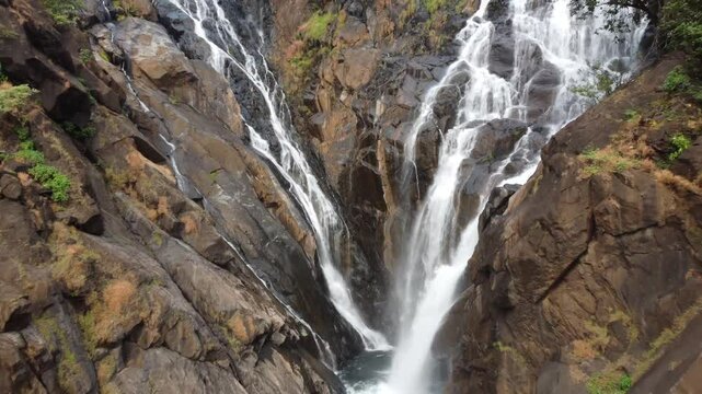 Aerial view of Dudhsagar Falls or Sea of Milk surrounded with lush vegetation located deep in the rainforest of South Goa, India.