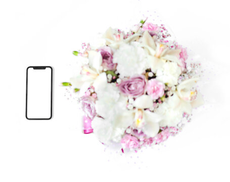 A phone with a white screen lies near the flowers isolated on a white background. The concept of online shopping. A gift for beloved woman. International Women's Day. Concept of love