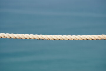 Nautical white rope line on a blurry blue sea background