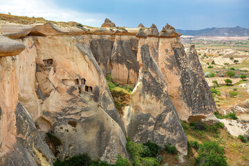 Fototapeta premium Unique rock formations stand majestically in Cappadocia's enchanting landscape.