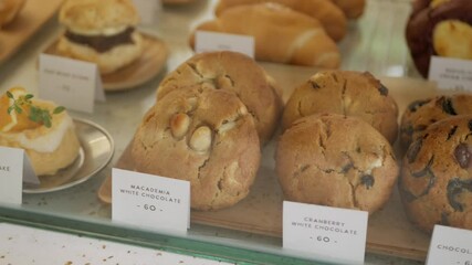 panning view inside the cafe full with bake homemade cookies in many flaovor, cookies in glasses showcase in homemade cafe restaurant coffee shop