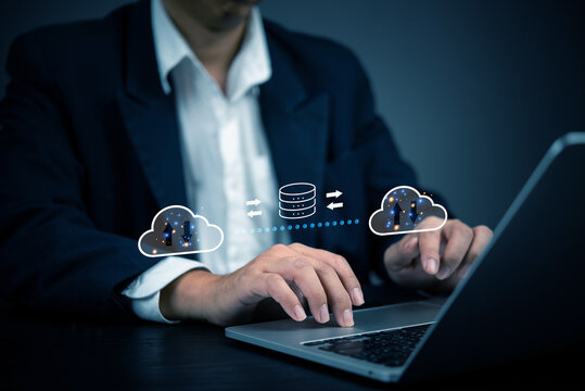 Businessman using cloud computing technology for data transfer and storage. Concept of cloud computing, data security, online storage, network infrastructure, and digital transformation in business.