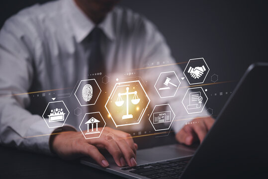 Businessman using a laptop with a digital law and justice interface, representing online legal services. regulations with AI legal services and technology.