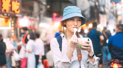 Asian tourist woman eating dessert at China town taste of asia street food market Bangkok, Thailand © dodotone