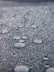 raindrops on tarpaulin grey background