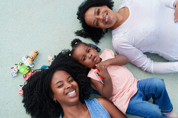 Happy family lying down and playing with toys
