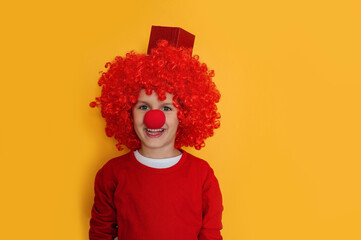 Funny kid clown playing at home. 1 April Fool's day concept.