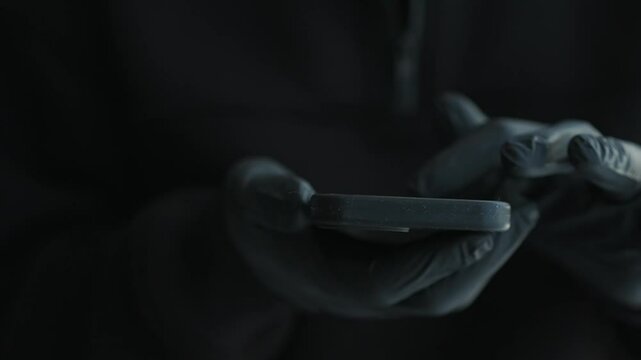 Male hands in black gloves click the phone.
PIN code on your phone.
Chklovek clicks on the phone's touch screen.
Black rubber gloves on hands.
A criminal wearing gloves unlocks the phone.
Phone, smart