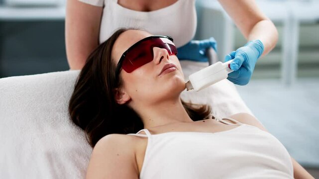 Young Woman Receiving Laser Epilation Treatment On Cheek