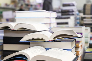 stack of books on the table. open book