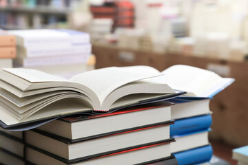 stack of books on the table. open book