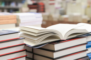 stack of books on the table. open book