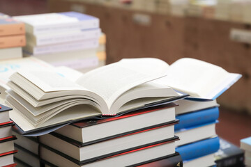 stack of books on the table. open book