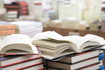 stack of books on the table. open book