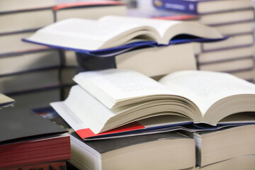 stack of books on the table. open book