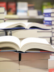 stack of books on the table. open book