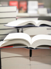 stack of books on the table. open book