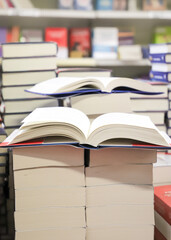 stack of books on the table. open book