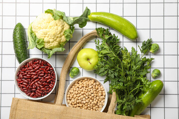 Set of vegan protein products in bowls and bag on light background, top viewSet of vegan protein products in bowl and bag on light background, top view