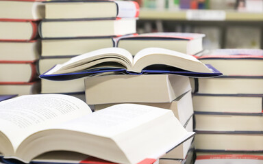 stack of books on the table. open book