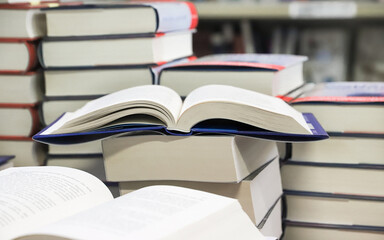 stack of books on the table. open book