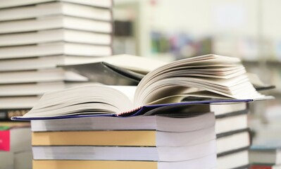 stack of books on the table. open book