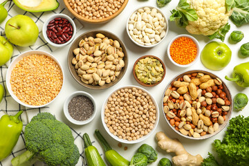 Set of vegan protein products in bowls and towel on white background, top view