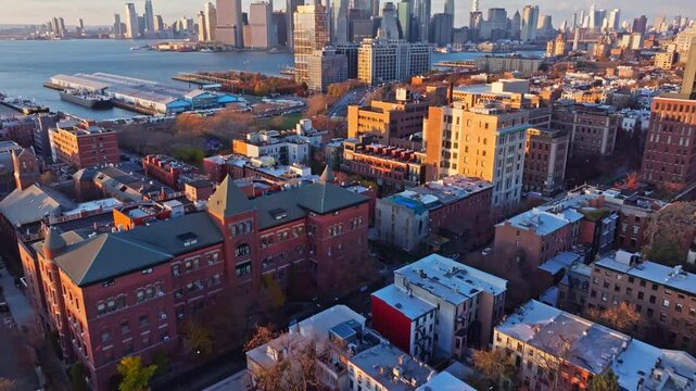 Red Hook waterfront with Lower Manhattan skyline during golden sunset, highlighting Brooklyn industrial landscape and urban waterfront scenery
